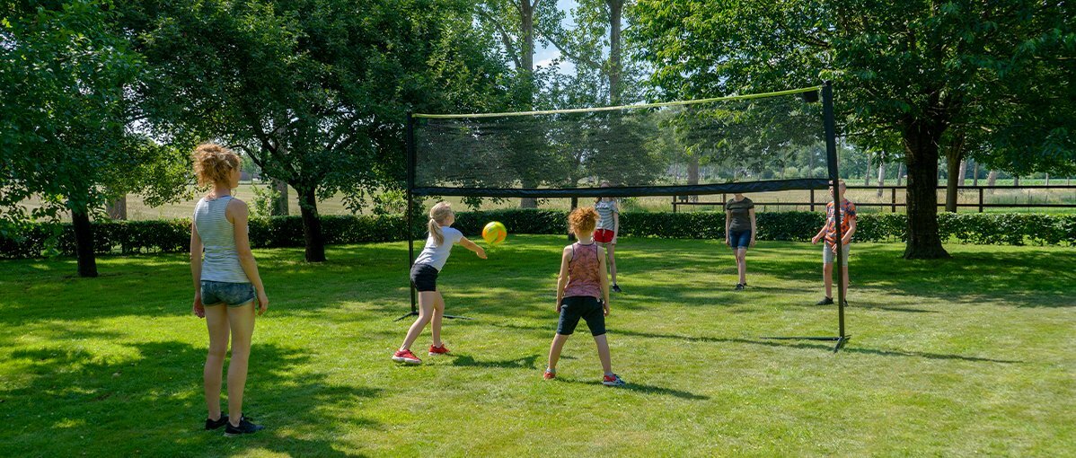 Image of the exit adjustable sports net in a garden with playing children.